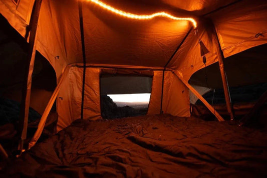 TUFF STUFF® Overland LED Light Strip USB illuminating a rooftop tent, showcasing amber light for a cozy camping atmosphere.