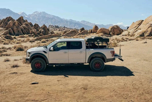 Tuff Stuff Overland Adjustable Roof Top Tent Truck Bed Rack in desert landscape.