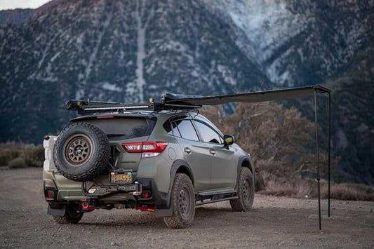 SKY RIDGE 4.5' Awning providing shade on an SUV in a scenic outdoor setting.