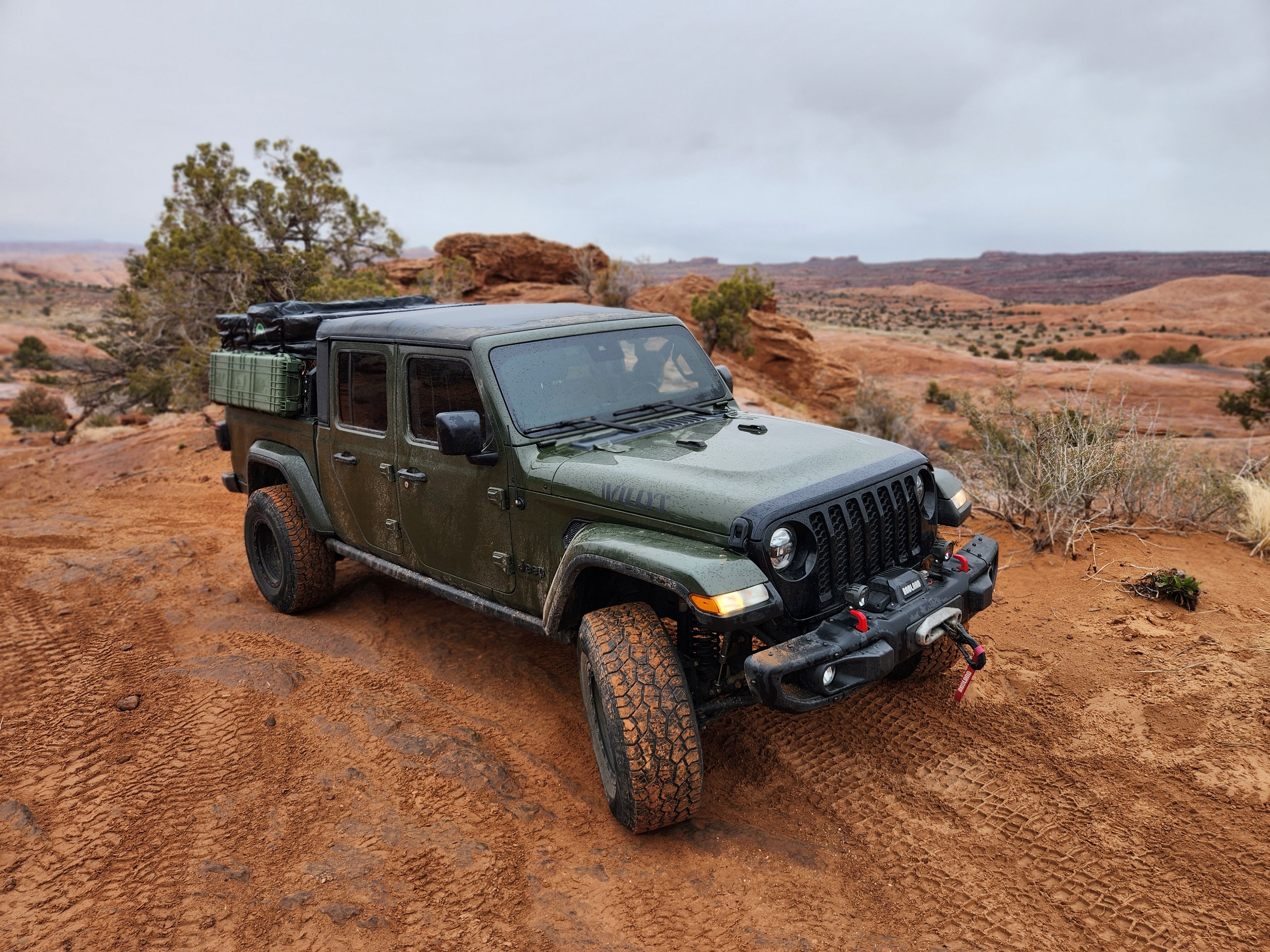 Green Jeep Gladiator in Moab Utah on a sandy Trail