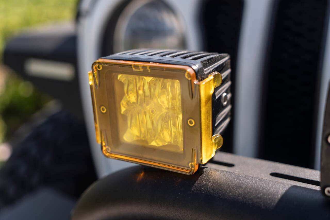 Durable polycarbonate cube light cover on LED light, enhancing visibility and protection.