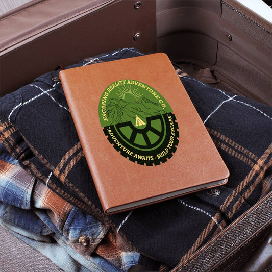 Adventure Notes Premium Leather Journal in suitcase on plaid clothing, perfect for outdoor enthusiasts.