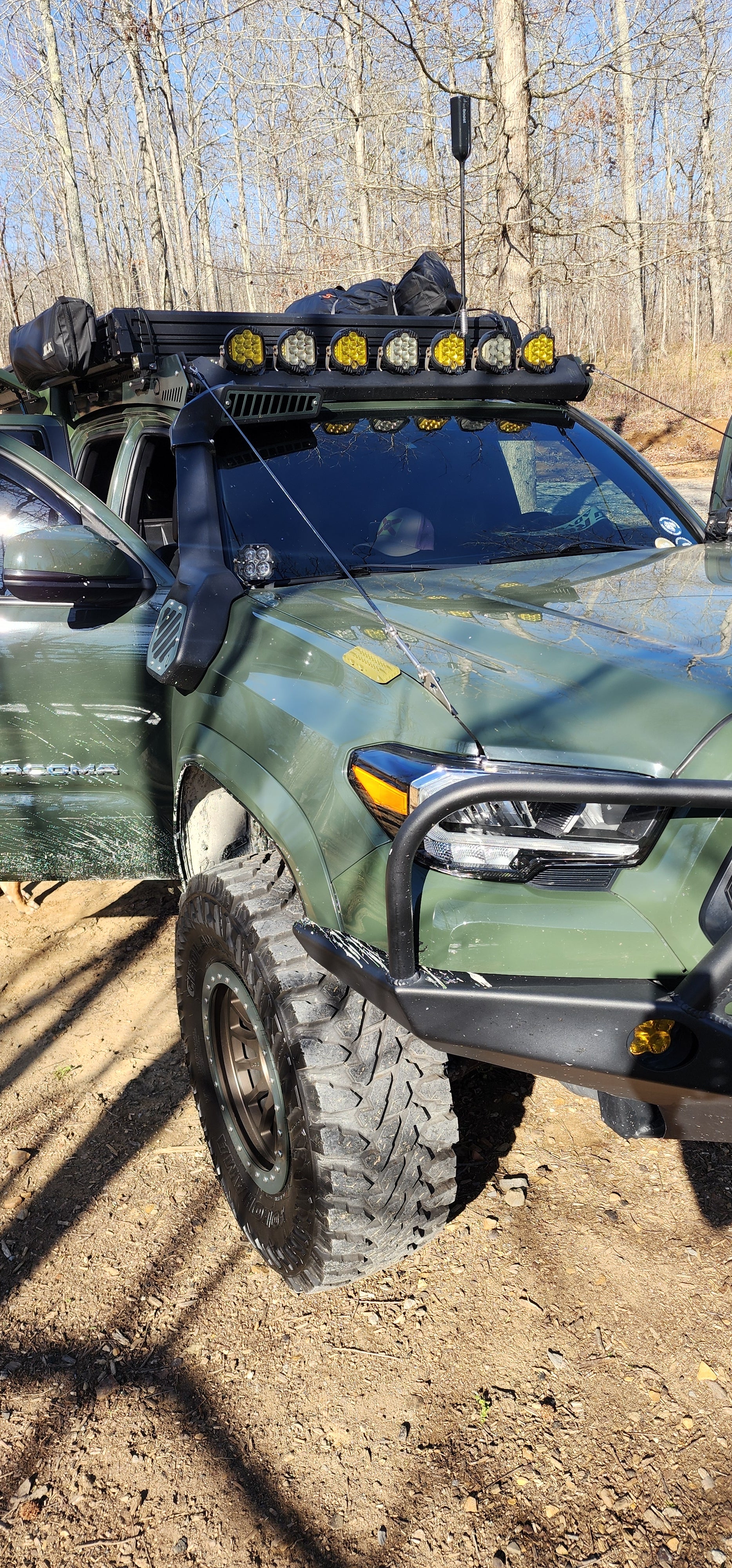 Green Toyota with a Widdle Traction Board Bottle Opener on the fender
