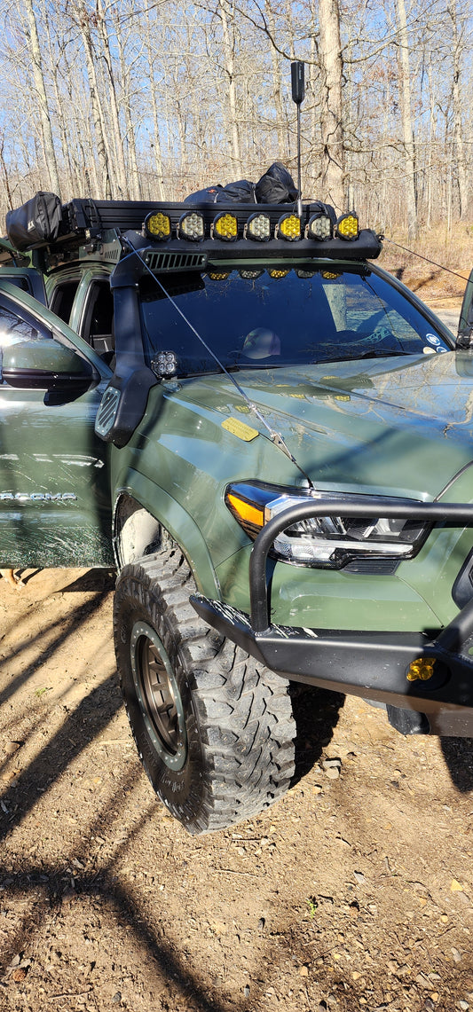 Green Toyota with a Widdle Traction Board Bottle Opener on the fender