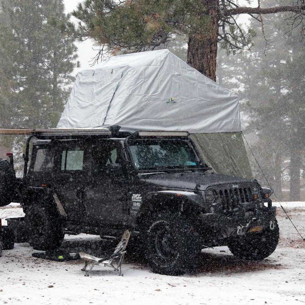 TUFF STUFF® Overland Roof Top Tent with Xtreme Weather Cover on Jeep in snowy forest.