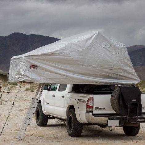 TUFF STUFF® Overland Roof Top Tent Xtreme Weather Cover on white truck, showcasing durability and weather resistance.