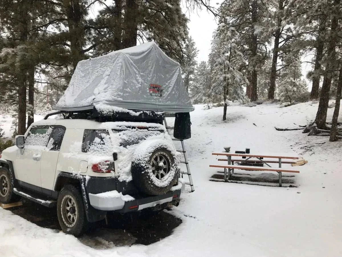 TUFF STUFF® Overland Roof Top Tent with Xtreme Weather Cover on a snowy campsite.