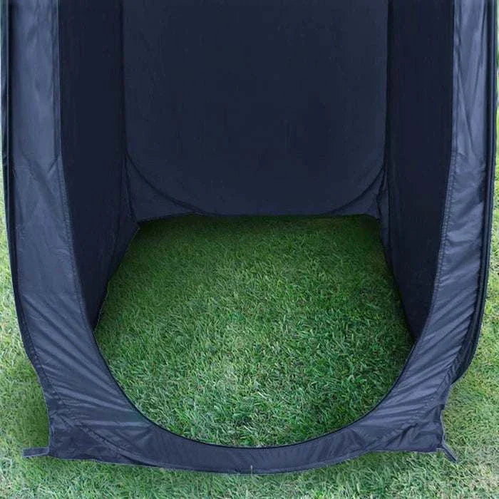 Portable outdoor changing or toilet tent on grassy field, featuring durable construction and easy setup.