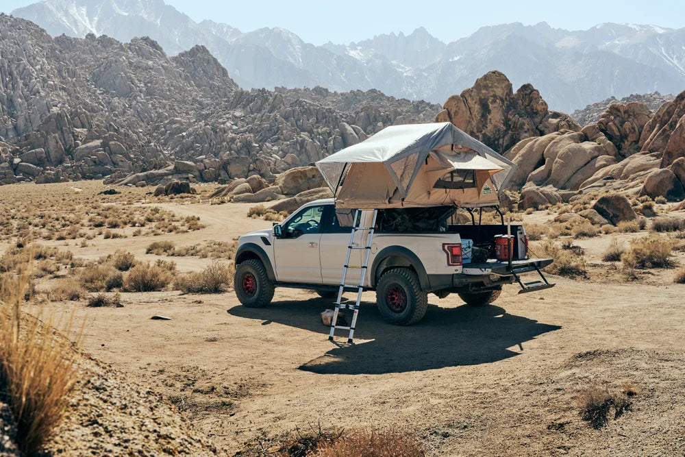 Trailhead Rooftop Tent, 2 Person, Tan setup on truck in rugged outdoor landscape.