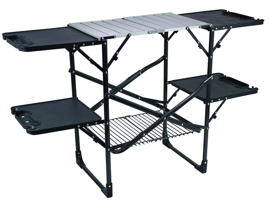 Portable camping kitchen with aluminum countertop, fold-out side tables, and lower storage rack – GCI Outdoor Slim-Fold Cook Station.