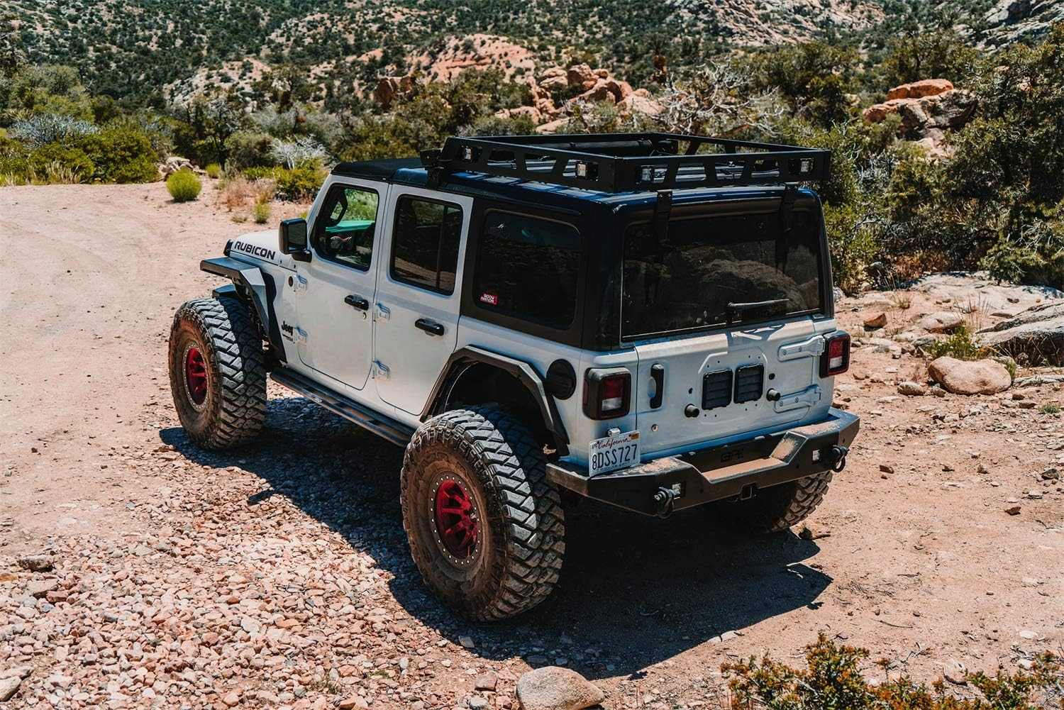 2018-2024 Jeep Wrangler JL with full-width rear bumper in rugged terrain.