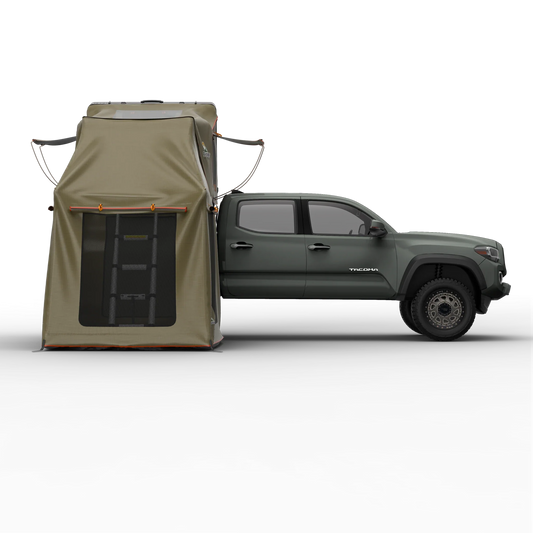 TUFF STUFF® OVERLAND ALPHA™ II clam shell RTT annex room attached to a vehicle, showcasing rugged 600D poly-oxford walls and large mesh-panel windows.