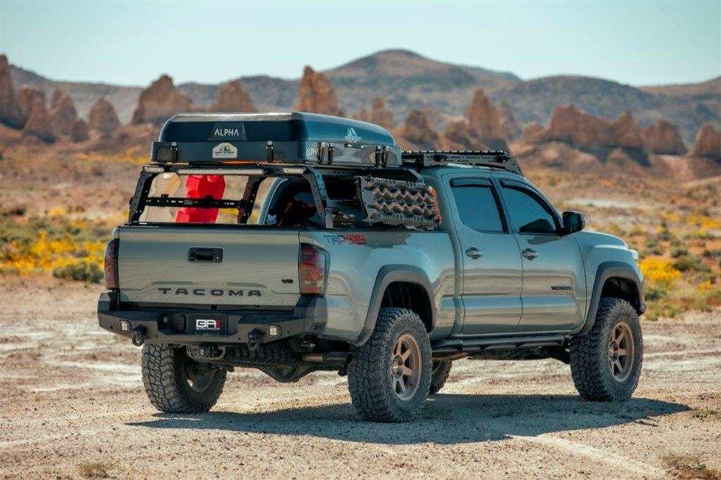 2016-2023 Toyota Tacoma with Pro Series II Rear Bumper and accessories in a rugged terrain.
