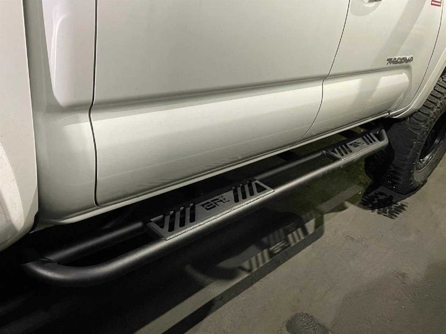 2005-2023 Toyota Tacoma Revo Step Sliders on truck, black powder coat, durable protection, and easy installation.
