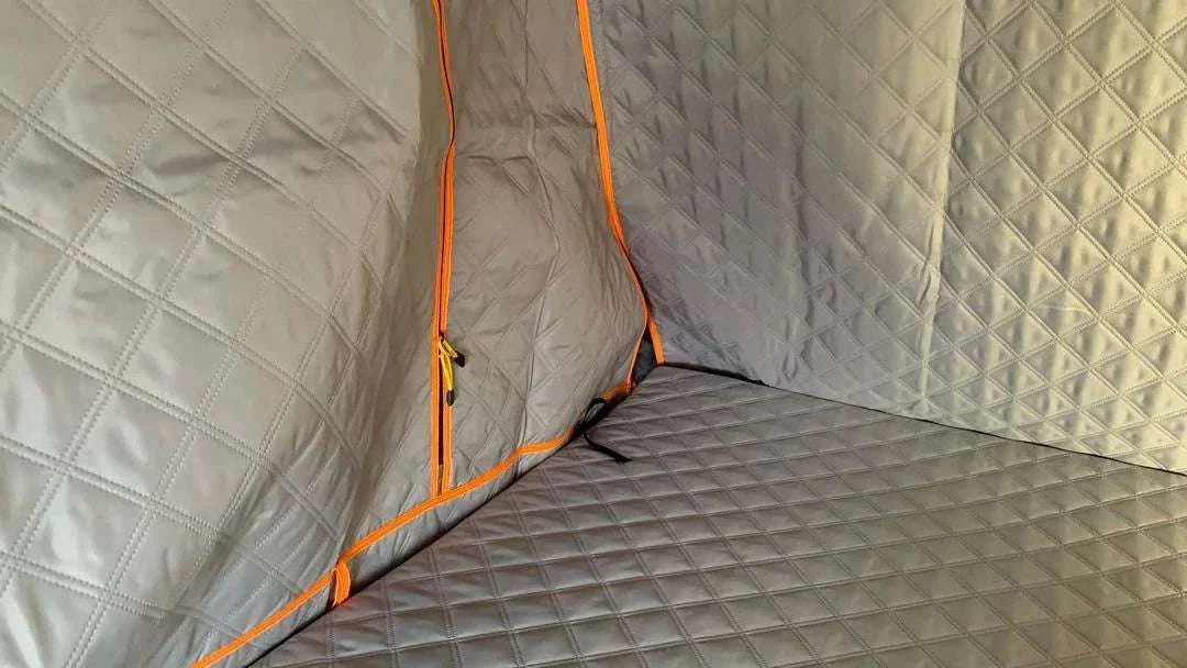 Insulated poly cotton liner for TUFF STUFF® OVERLAND ALPHA™ II roof top tent, showcasing quilted design and orange zipper.
